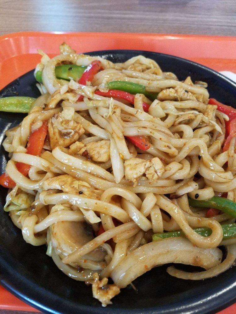 Stir-fried udon noodles with chicken, peppers, and vegetables
